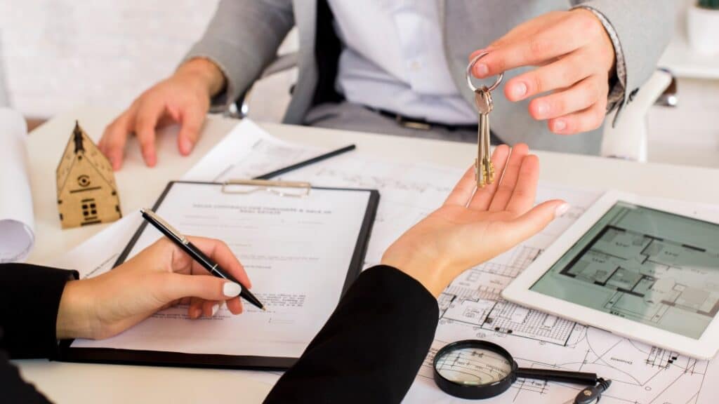 Handing keys whilst signing a short term rental contract.