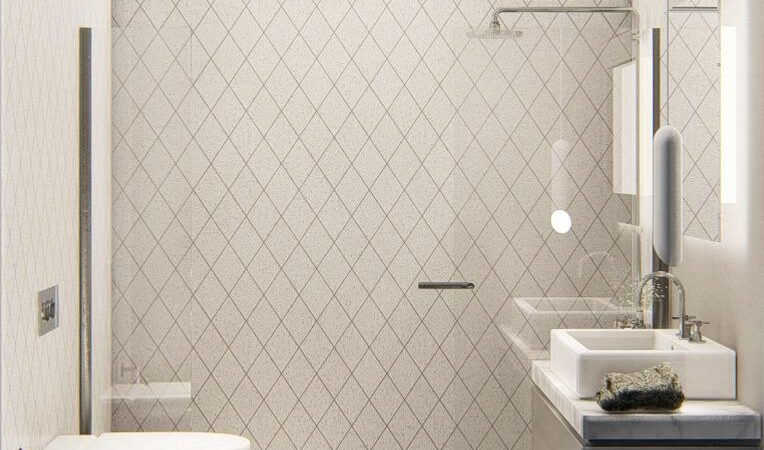 Side view of the bathroom showing the WC, sink unit in navy blue, shower, and herringbone tile in beige.