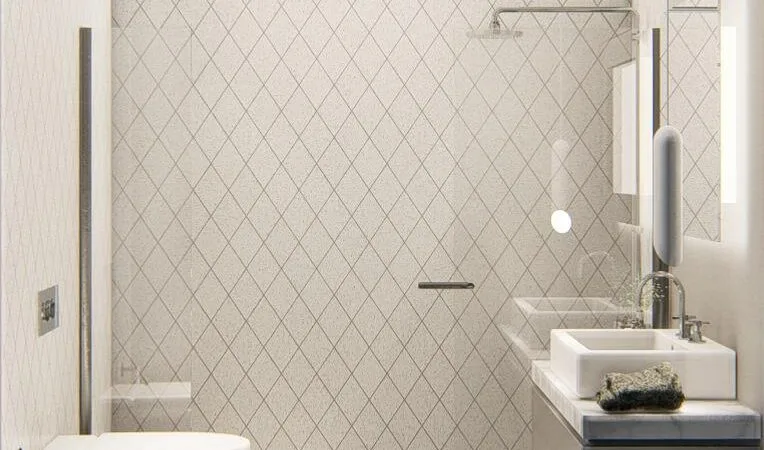 Side view of the bathroom showing the WC, sink unit in navy blue, shower, and herringbone tile in beige.