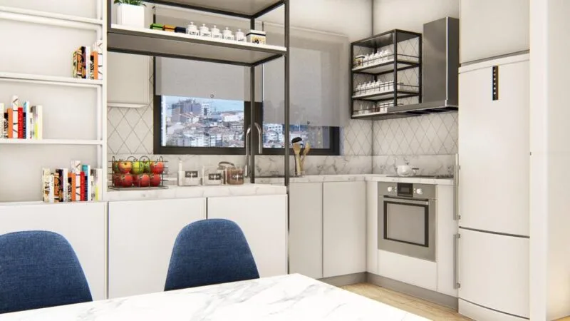 Side view of the kitchen with the window over the sink, white units and oak parque flooring