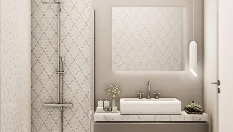 Bathroom showing the sink unit and shower, with a mirror. Walls decorated in neutral colours.