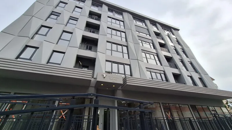 Apartment building in Besitkas - exterior view showing store front and six storey building