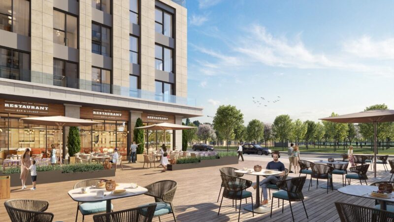 Ground level showing seating space and the apartment block