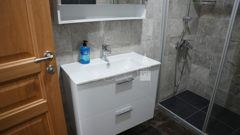 A view of the bathroom sink in white and vanity mirror