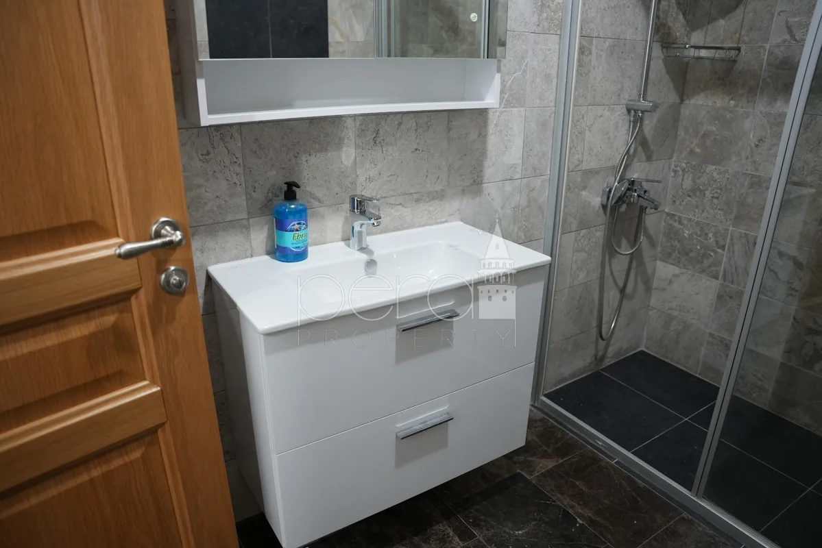 A view of the bathroom sink in white and vanity mirror